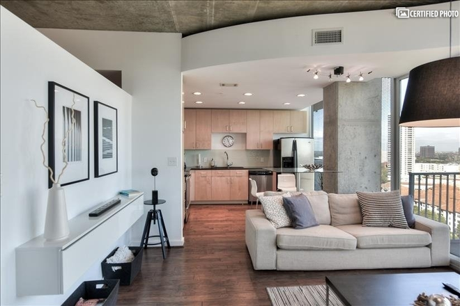 Living room - Stylish 1-bedroom, 1-bath high-rise condominium with a stunning view of Downtown Houston