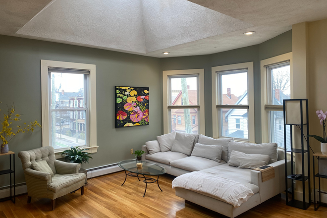 Sunlit living space with high ceilings - Fully-furnished Inman Square Condo for Summer Rental