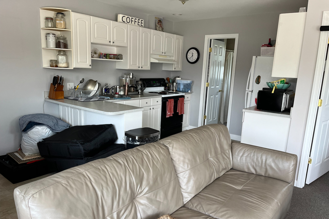 a shot of the kitchen, standing in living room - Wycomb Pl & Welesley Ln Apartments