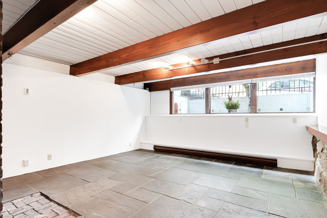 Open space of studio with beams and slate - Architect-designed studio apartment on Beacon Hill in 3-unit building