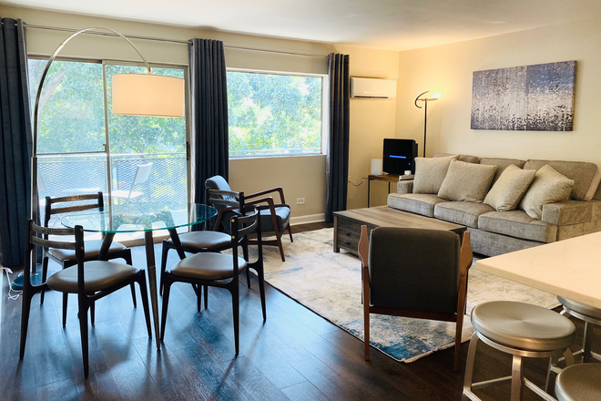 Living Room with sliding door to balcony. There's a TV but it's not shown in the picture - One bedroom in furnished 2 BR/1BA apartment. Less than 10 min. walk to campus and hospital.