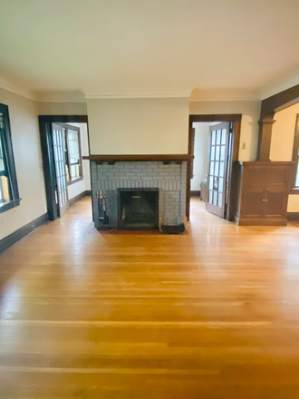 Living Room (sunroom behind firepplace) - Quiet 3 bedroom upper unit duplex, 1 block from campus