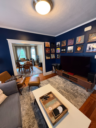 living room - 2BR Condo Near Harvard (12 mins) – Private Laundry, Deck & Water Included