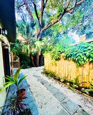 Private Entry way with a gate and walk path to the cottage. - Tropical Coconut Grove Cottage