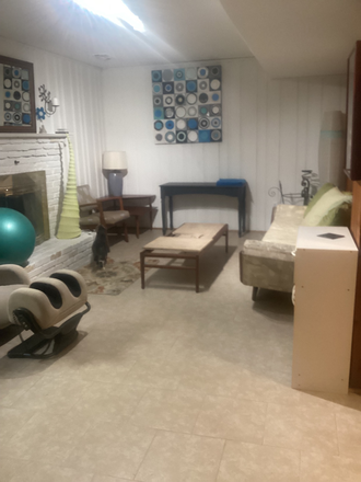 Living room east end with furniture and massage chair. Could be removed if desired. - Bright Basement Apartment in SFH at Glebe, S. 16th, Walter Reed Dr.