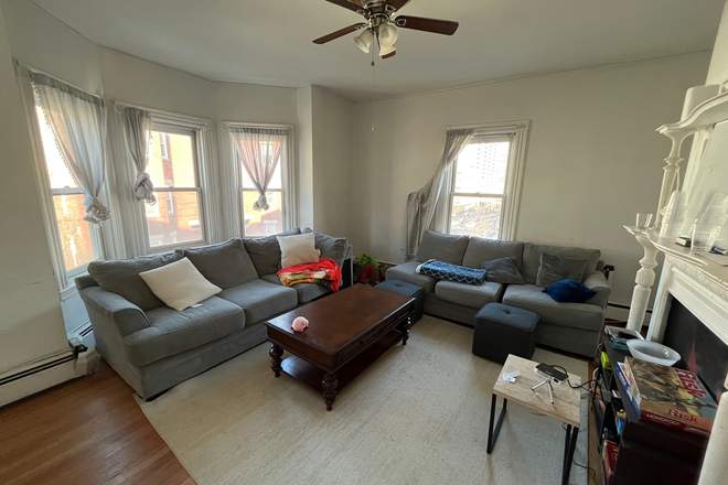Living Room - Four bedroom with two full bathrooms, central air conditioning and will have Laundry in unit Apartments