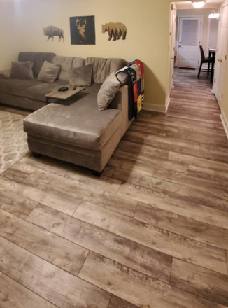 Living room with couch included in rental - Sterling Park Apartments