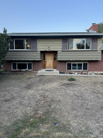 front of house view from street - Four bedroom two bath house with large back yard and garage