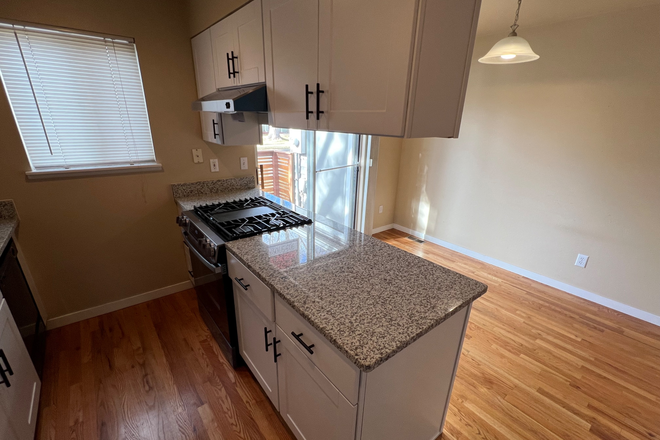 Cooking island in kitchen with new gas range and oven - Clean Spacious 3 Bedroom, 4 Bath Boulder Townhome
