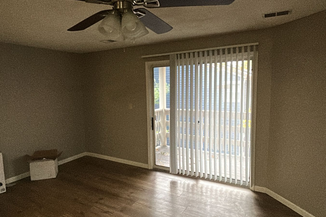 Living Room with Balcony view - Salem Courthouse Apartments