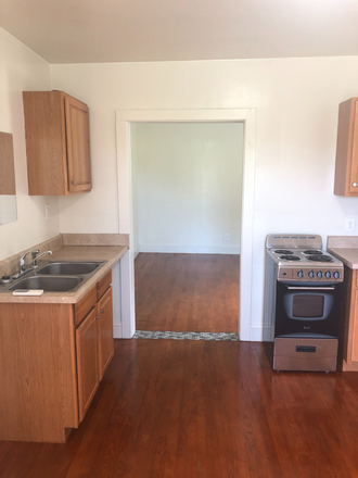 Living space/kitchen area looking into bedroom - Studio Apartment All utilities included