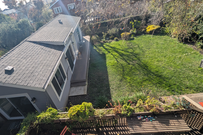 Outside View of ADU overlooking a large garden - Gorgeous Elmwood 2BR Modern ADU with Pristine Deck and Garden