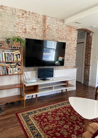 Living room with exposed brick - The Lofts at Odd Fellows