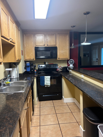 Kitchen with fridge, dish washer, oven, and microwave - Le Boulder Buddha Apartments