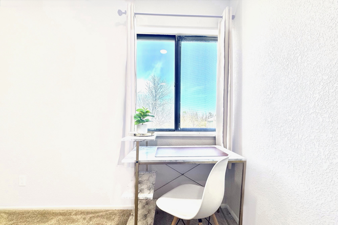 Desk by window in primary room - Furnished 2BR Condo Near Anschutz Medical Campus