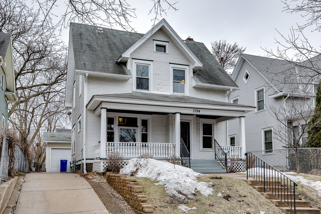 Front of home with inviting front porch - New Listing! Beautifully updated on quiet street. Walk to campus. 3-car garage
