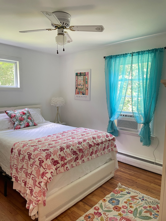 Smaller bedroom includes dresser, 2 nightstands, double bed, television. Linens available. - Cozy Westerly 2 bedroom