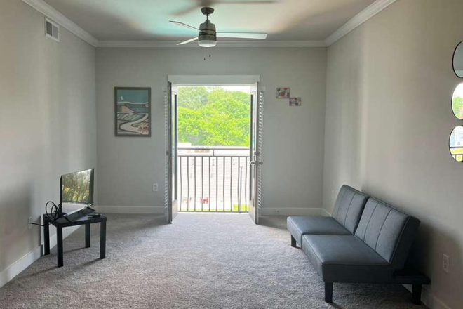 Bright Living room and Patio lookout - Furnished Midtown Atlanta apartment near Emory University Hospital!