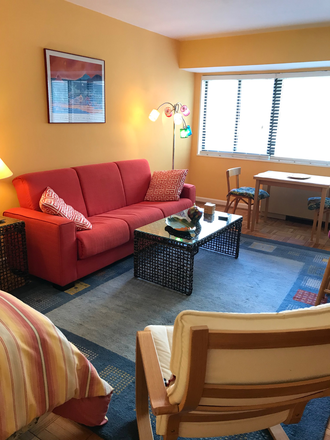 Living area and dining table. - Large cheery studio with EXTRA WORK SPACE 1 block from Metro