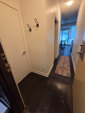Entryway with coat hooks, coat closet and laundry closet - Furnished 1 bed/ 1 bath private condo close to Osgoode station