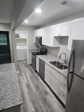 Kitchen with stainless steel appliances including Microwave, Range, Dishwasher, and Fridge/Freezer - AND there are double sinks! - Updated 2 Bed 2 Bath Apartment, Open Concept, Full Size W/D in Unit, Move-in Ready!