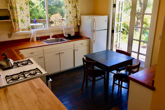 Kitchen with French doors to gardeni - Home with apt. Easy access to campus