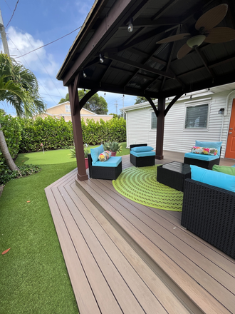 Backyard with deck and putting green - Fully Furnished 2BR Home - Flexible Lease Terms - Move-in Ready