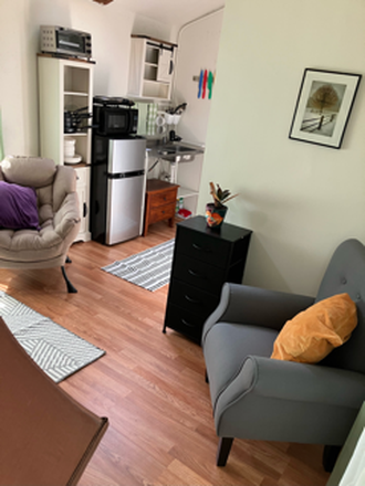 Seating area and kitchen - Adorable furnished cottage. Short walk or bike to Cal. Great neighborhood.