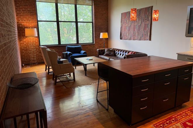 Main living/dining area - Fully furnished tobacco warehouse loft