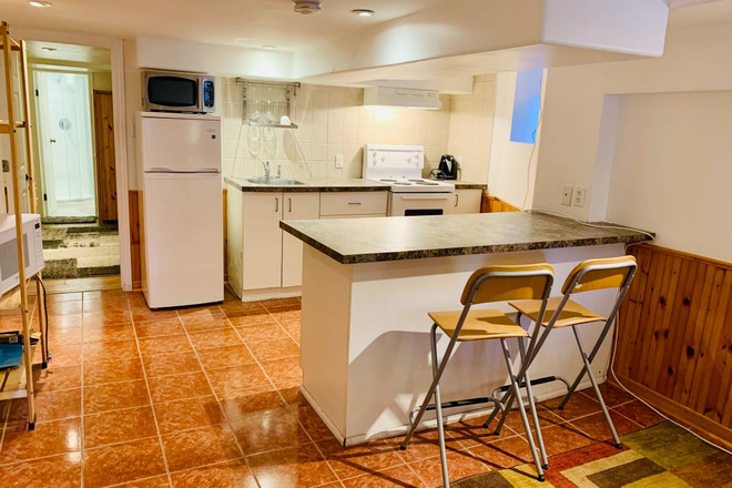 Kitchen with island - Bright one bedrm bsmt apt (Toronto - St Clair West) - Jan 1st, 2026