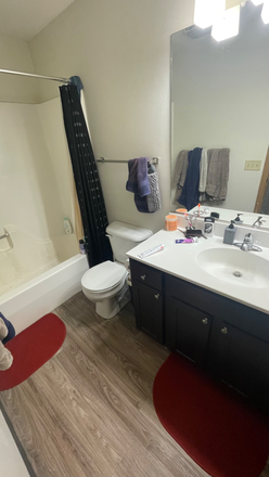 Full bathroom with large mirror - Hyland Ave Apartments