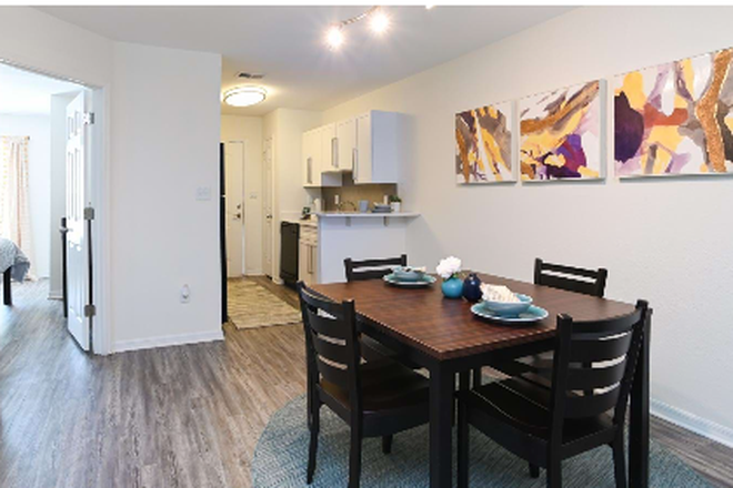 Promotional showroom picture from the common area looking towards the kitchen and room A. - University Townhomes at Charlotte