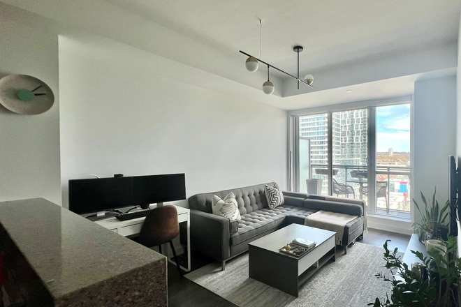 -Living room & balcony - Furnished 1BR/1BA+Den with Laundry 685 sq ft 12th-Floor Modern Condo in Regent Park