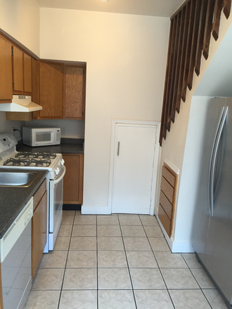 Other side of kitchen with your own furnace behind the white door - Rochelle Apts Apt 4