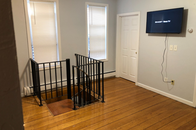 Living room view 1 - Beautiful, renovated 2BR townhouse style unit with office, near T, with laundry in building