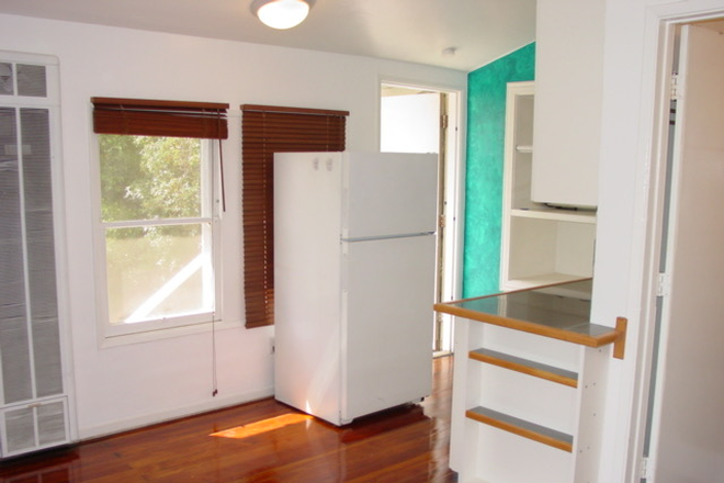 The studio's front door next to the fridge - Studio for Rent Apartments