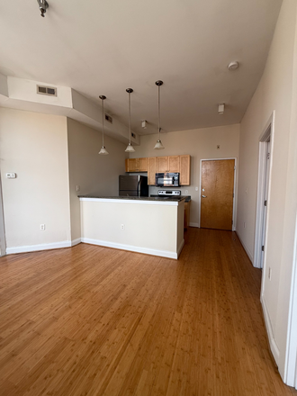 #310 - living room/kitchen - Spacious Living & City Views – 1 & 2 Bedroom Homes at Eagle Mill Towers