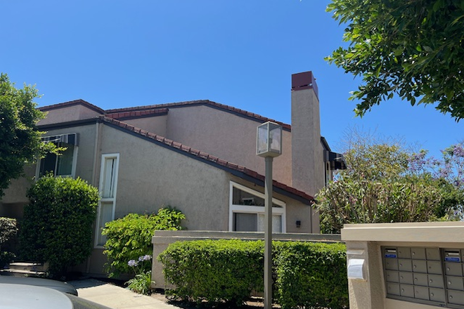 Side view of 377 Stanford two story townhome with car and mailboxes in the foreground - 377 Stanford Court. 3 Bedroom, 3 Bath townhome, quick walk to UCI, nicely remodeled, parking, yard