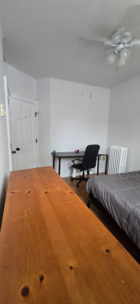 Bedroom pic#2 (notice closet door on left, and desk with chair) - Room for Rent in Fully Furnished Rowhouse in Charles Village