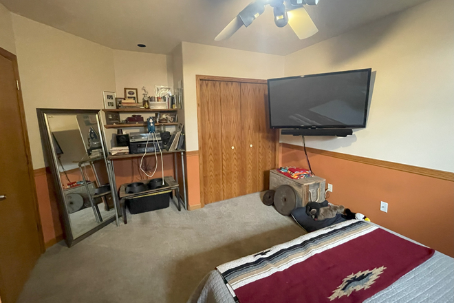 Bedroom with current lodger's stuff. The bedroom can be rented unfurnished or with modest furnishings ($100.month extra). - Private Furnished Bedroom and Bath on West Pearl Street - Unfurnished Optional House