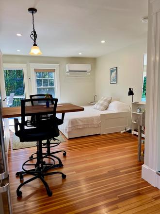 Main space, including bed, desk, and dining table - Furnished room(s) in gracious neighborhood -- walk to town, college, parks, bus