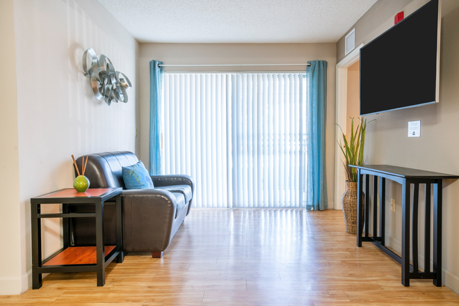 living room with bedroom closest to balcony (couches and table included) - Knight Circle 4x4 apartment ALL FEMALE
