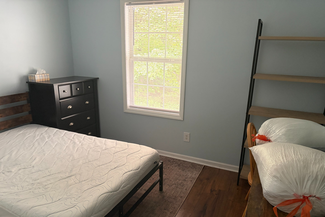 Bedroom with shelf and desk. Not in the picture, but there is also a closet for extra storage and a ceiling fan for keeping cool. - Trailwood Heights Condos on Route 11 Bus Route, close to campus