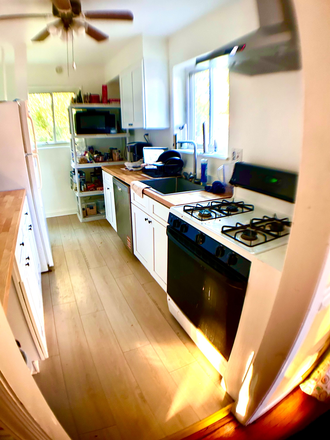 kitchen has new cabinets and butcherblock countertops - Close + Spacious House -- Just Remodeled -- 5 Bedrooms, 2 Baths and more! Available Now