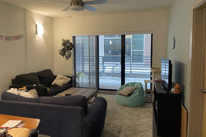 Living room and balcony, Available Room with Ensuite through door shown on the right - The Square Apartments