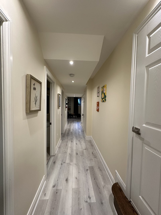 Hallway from bedrooms to living room and entrance - Newly furnished 2-bedroom basement, 6 min to Lawrence Station, private laundry, quiet area. House