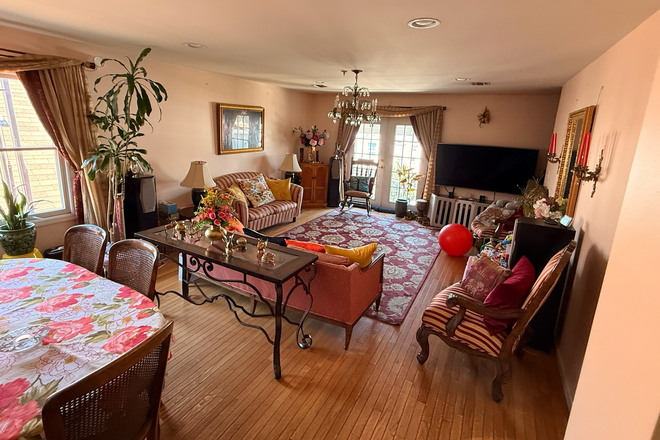 Living room and dining room toward balcony (of identical unit) - Spacious beautiful 3 bedroom with quick commute to Manhattan