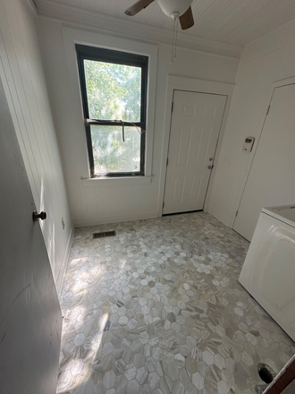 Back entrance into the mud room with washer and dryer and all new marble flooring - 4 bd/2 bth house with fenced in yard, w/d, hardwood floors, fireplaces & fully renovated bathroo