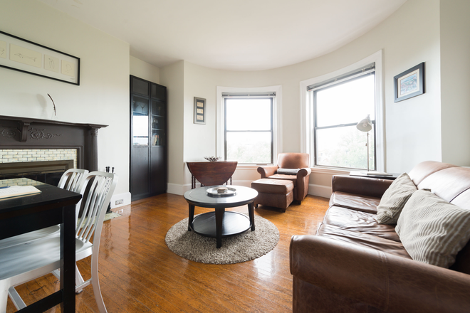LIVING ROOM WITH WORKING FIREPLACE - PENTHOUSE 1-BEDROOM WITH VIEWS AT THE CARLYLE, NO BROKER FEE, AVAILABLE SEPT 1 OR SOONER