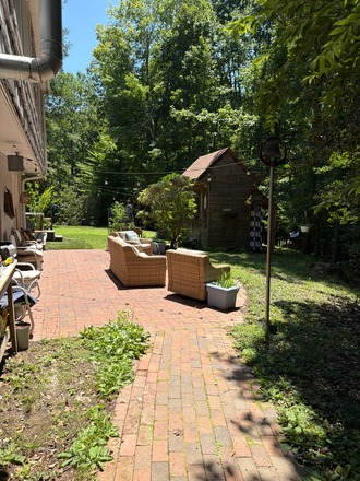 Back patio - Easy walk or bike to campus. Quiet woodland view. House